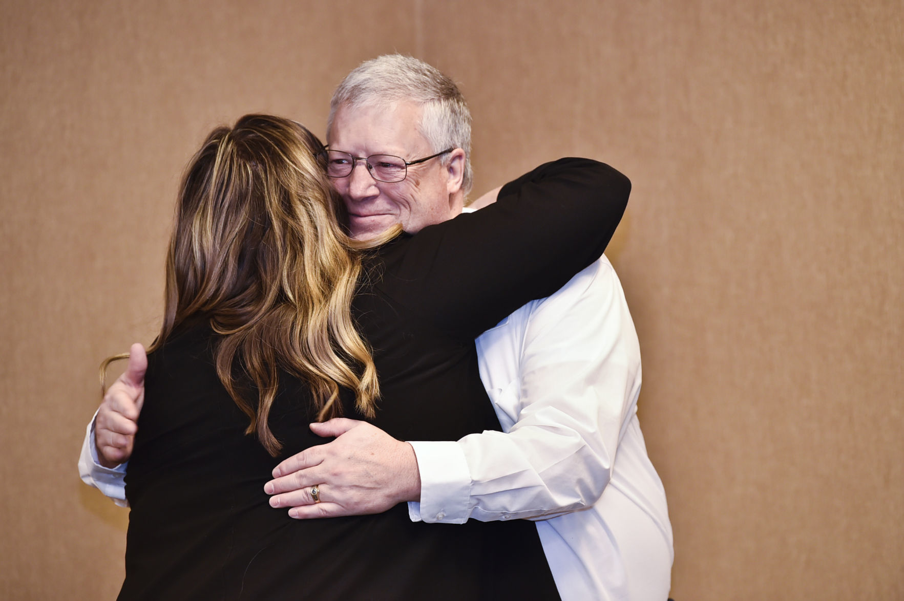 Mike Merganthaler, vice-president of the Chamber of Commerce, hugs Kali Wicks